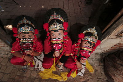 Three tradisional mask dancer with red costume