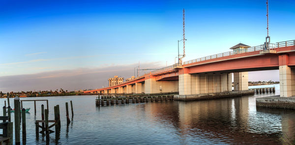 Bridge over river against buildings