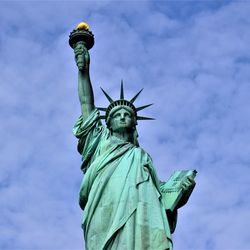 Low angle view of statue of liberty against sky