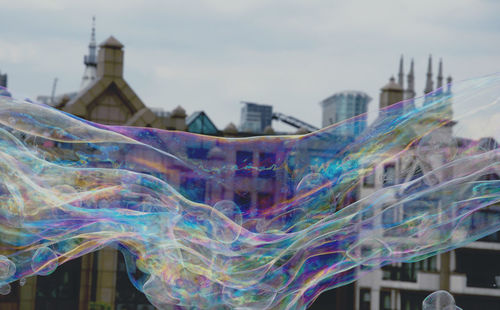 Long bubble flying against building