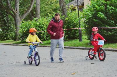 Rear view of women riding bicycle