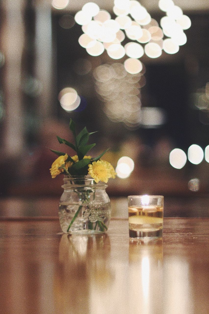 CLOSE-UP OF FLOWER ON TABLE