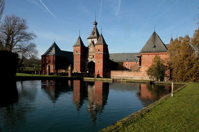 View of lake and buildings against sky