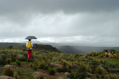 Full length of man standing on land against sky