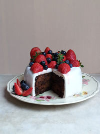 Fruit cake with fresh strawberries and blueberries