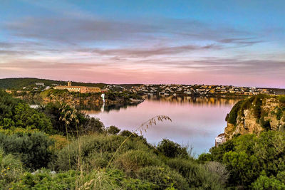 Scenic view of lake against sky during sunset