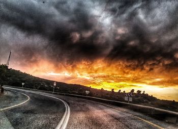 Dramatic sky over road during sunset