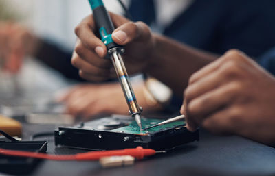 Midsection of man working on table