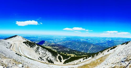 Scenic view of mountains against blue sky