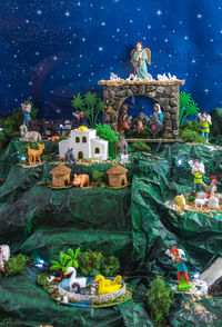 Traditional temple by sea against sky at night