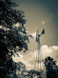 Low angle view of windmill against sky