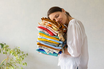 Woman embracing clothes at home