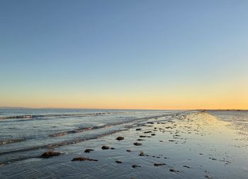 Scenic view of sea against clear sky during sunset