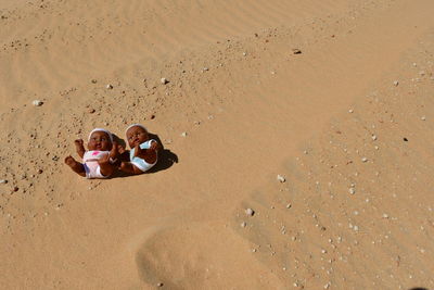 High angle view of dolls on sand at beach