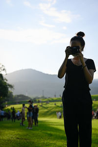 Series photo of young women with camera in public park outdoor on sunny day