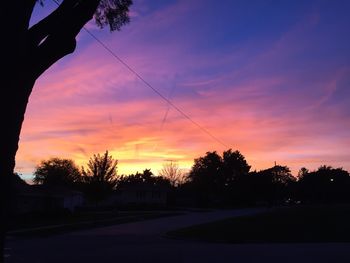 Silhouette trees against sky during sunset