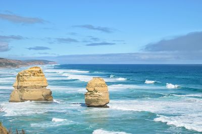 Rocks on sea shore against sky