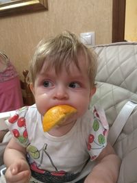 Portrait of cute boy eating food at home