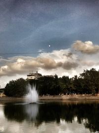 View of waterfall against cloudy sky