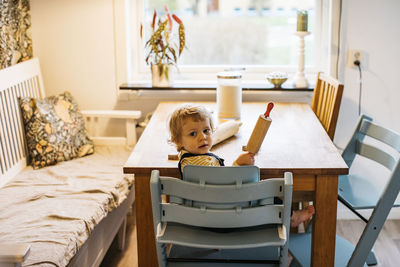 Portrait of boy holding rolling pin