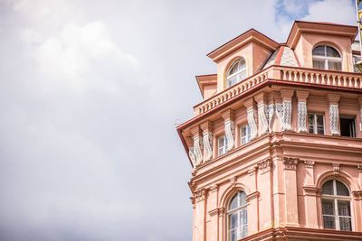 Low angle view of building against cloudy sky