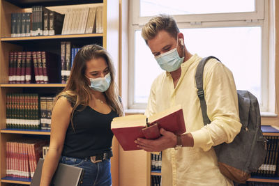 Young couple holding book