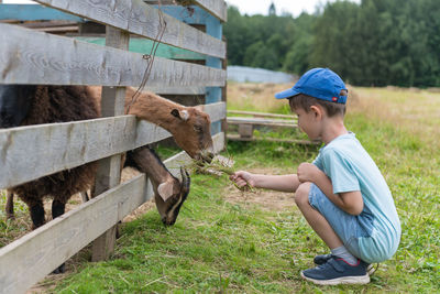 Side view of boy climbing outdoors