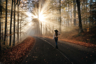 Rear view of man walking in forest