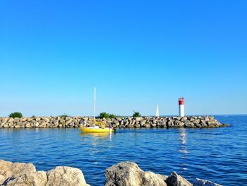 Scenic view of sea against clear blue sky