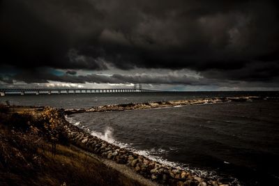 Scenic view of sea against storm clouds