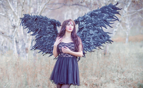 Beautiful young woman wearing angel costume