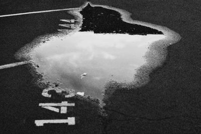 Reflection of road in puddle