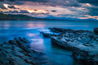 Scenic view of sea against sky at sunset