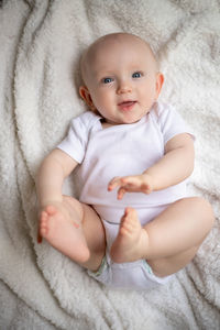 Close-up of baby boy sleeping on bed at home