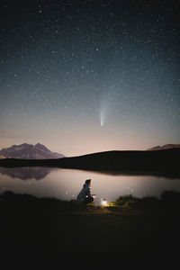 Scenic view of lake against sky at night