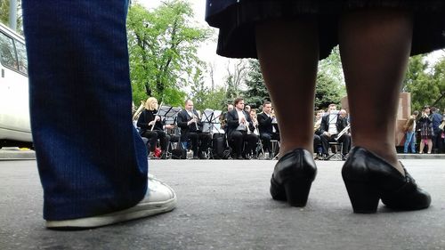 Low section of people standing on street