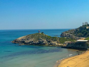 Scenic view of sea against clear blue sky