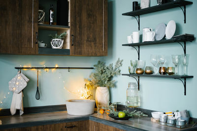 Festively decorated wooden kitchen with blue walls in scandinavian style