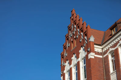 Low angle view of building against clear blue sky