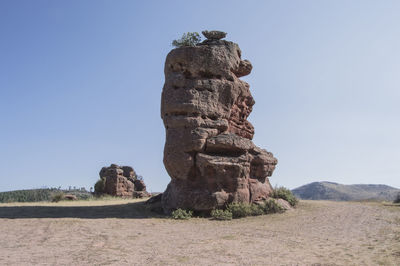 Stack rock on field against clear blue sky at parque natural del alto tajo