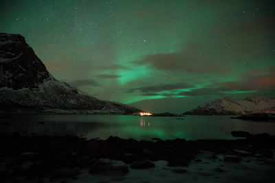 Scenic view of lake against sky at night