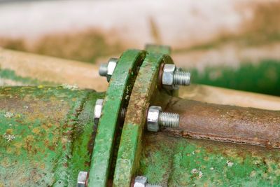 Close-up of rusty metal on wood
