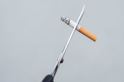 Low angle view of cigarette against white background