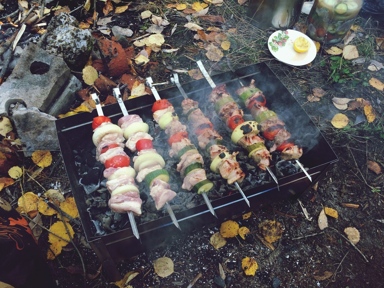 high angle view, food and drink, food, freshness, large group of objects, preparation, still life, abundance, barbecue grill, street, cooking, day, outdoors, healthy eating, metal, barbecue, preparing food, leaf, heat - temperature