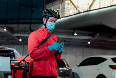 Midsection of man standing in car