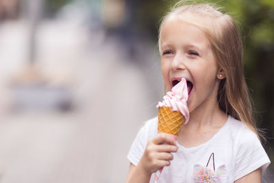 Close-up of girl blowing ice cream cone