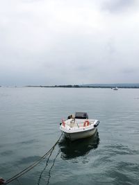 Boat sailing in sea against sky