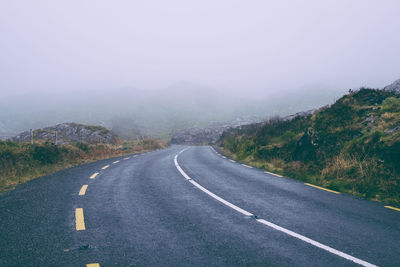 Road amidst mountains against sky