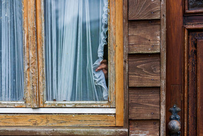 Man standing on wooden door of house