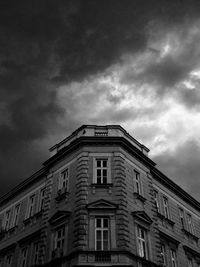 Low angle view of building against cloudy sky